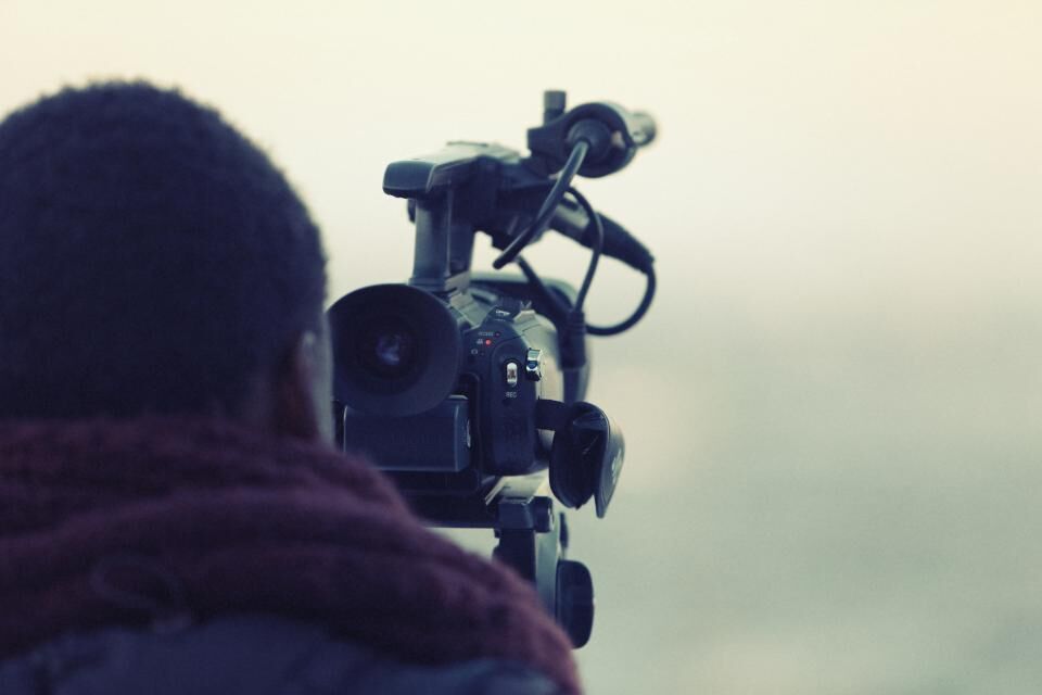 Videographer operating a professional camera
